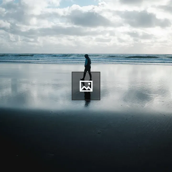 Person walking on beach reflection