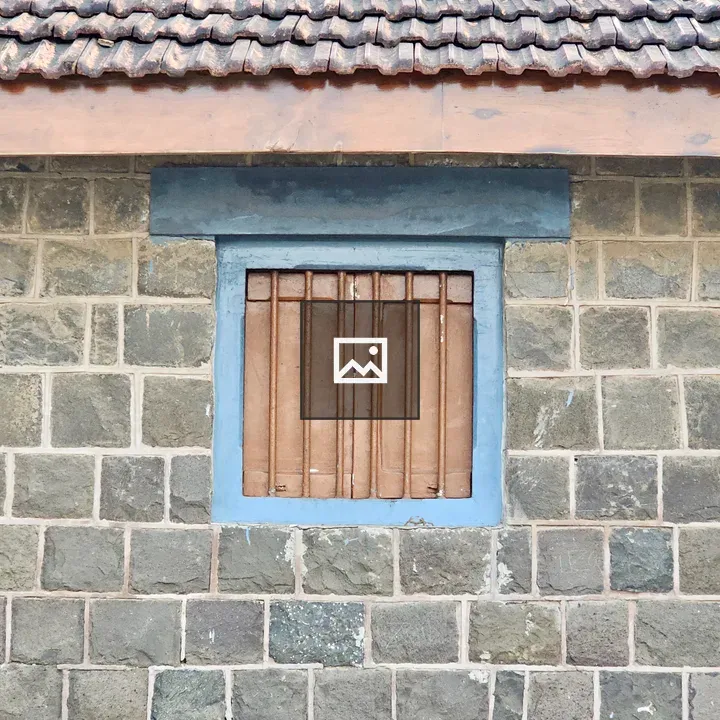 Closed wooden window with blue frame