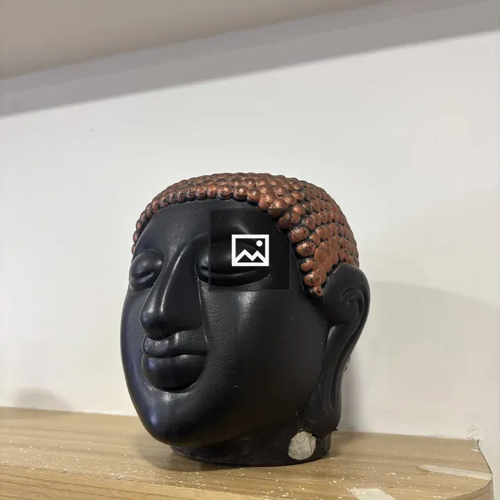 Decorative black sculpture of a face