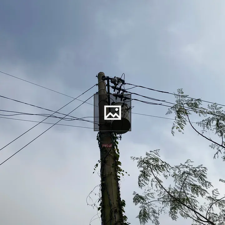 Tall utility pole with tangled wires