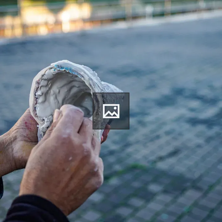 Hands of an artisan distributing clay