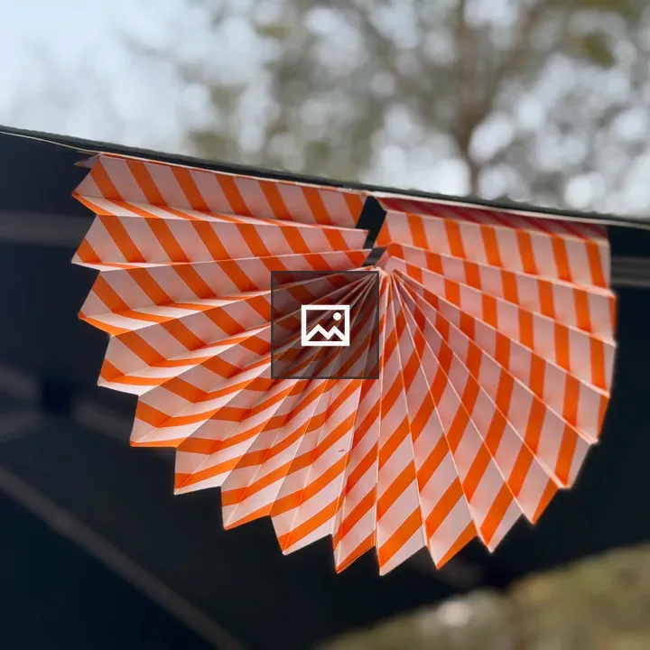Orange and white striped paper fan