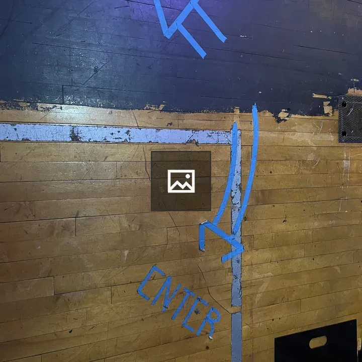 Blue tape arrows on stage floor