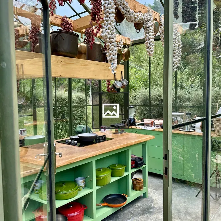 Green kitchen in a glass house