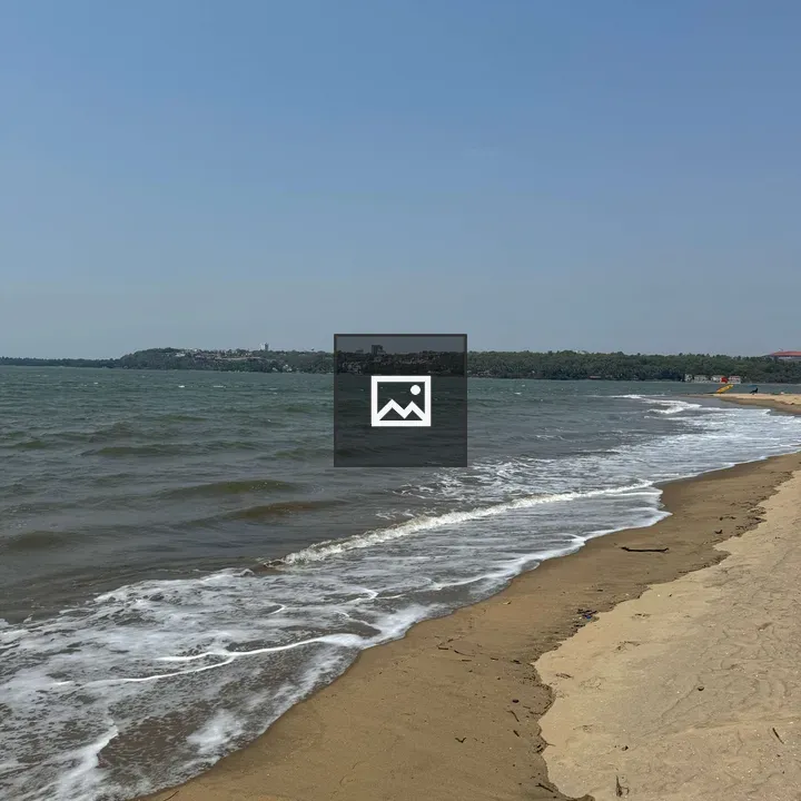 Sandy Beach and Choppy Greenish Water