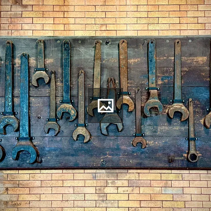 Wall-mounted antique wrenches display