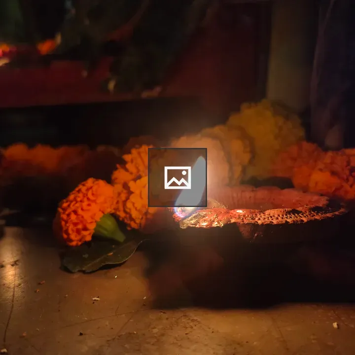 Lit oil lamp with flowers