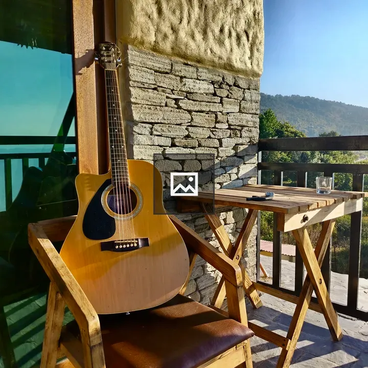 Wooden acoustic guitar on balcony