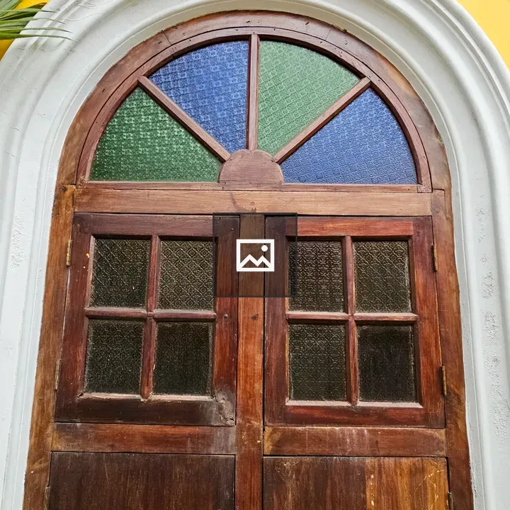 Old wooden door with colored panes