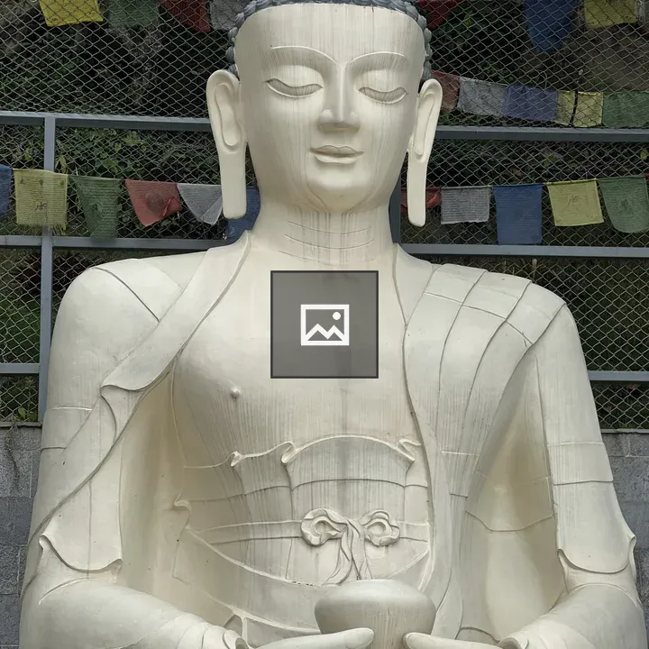 Seated Buddha Statue with Prayer Flags