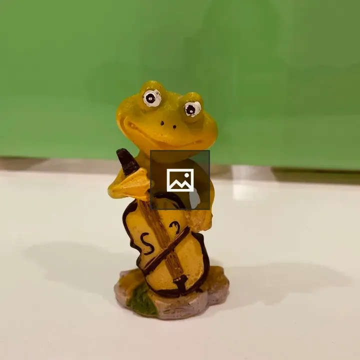 Yellow frog cello figurine