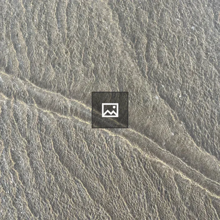 Top view of beach waves on sand