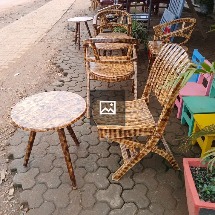 Ornate wooden chairs and tables along sidewalk