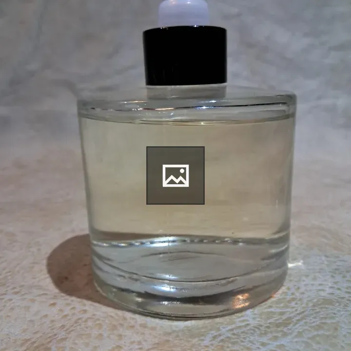 Clear glass bottle with white nozzle