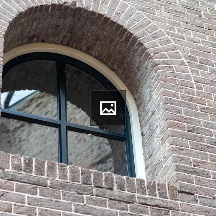 Arched window with brick wall