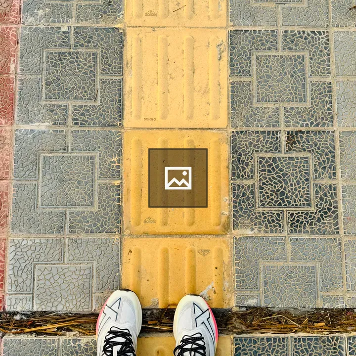 Top-Down View: Sneakers on Tactile Tiles