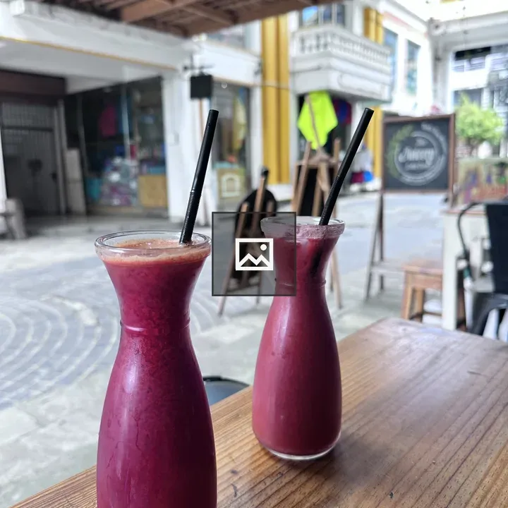 Two Glass Bottles with Red Juice