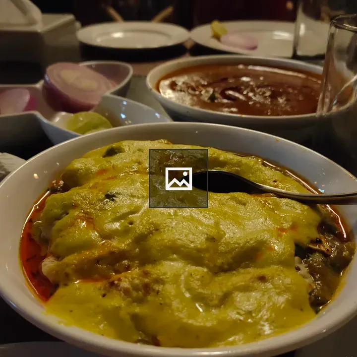 Punjabi dish with green sauce on table