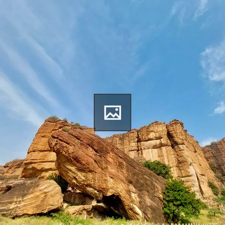 Sunlit Red Sandstone Cliffs of Badami