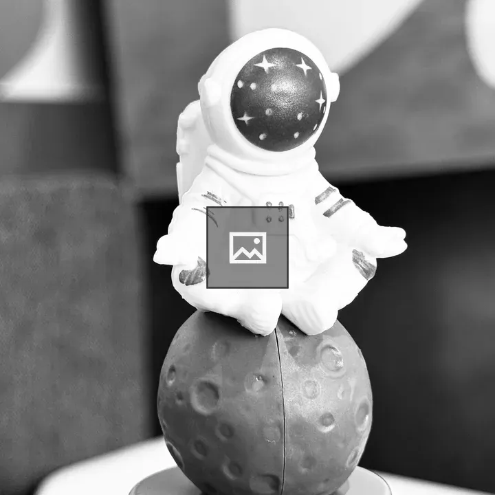 Astronaut Figurine on Moon-like Sphere