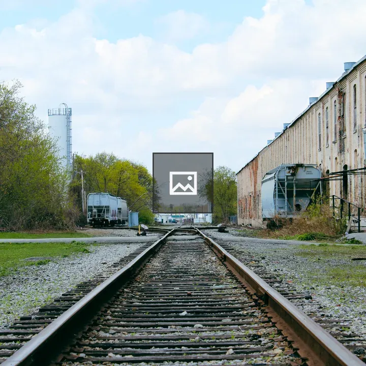 Railroad tracks behind abandoned factory
