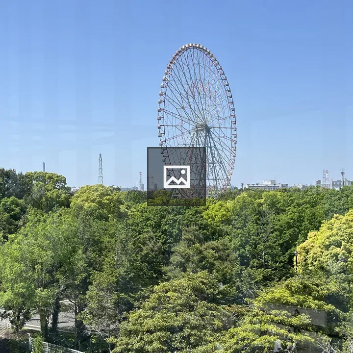 Ferris wheel over forested landscape