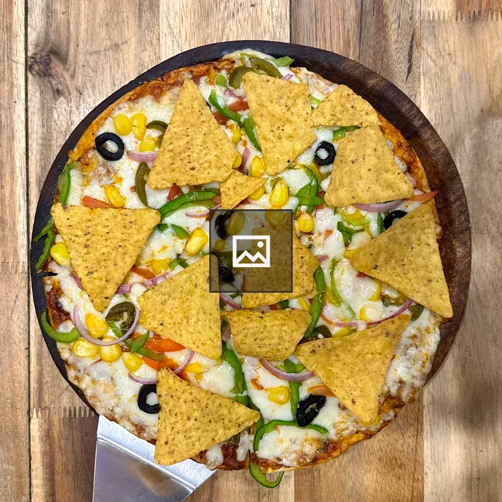 Pizza with corn and olives on wood