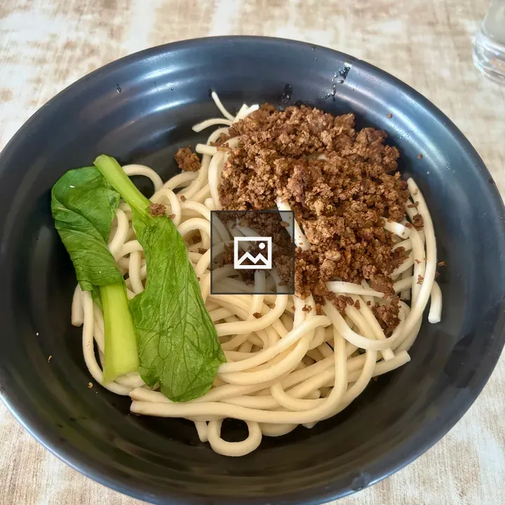Noodle dish in black bowl