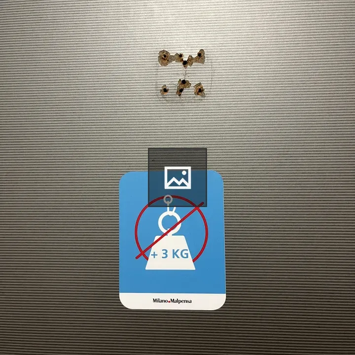Hook with sign on wall