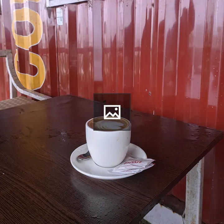 Latte in white cup on table