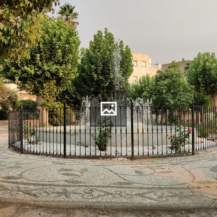 Fenced Fountain in Urban Park
