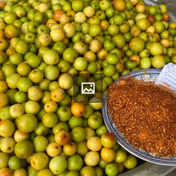 Pile of green and orange fruits