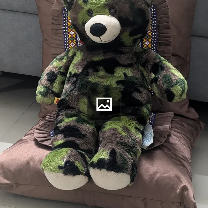 Plush bear on cushion
