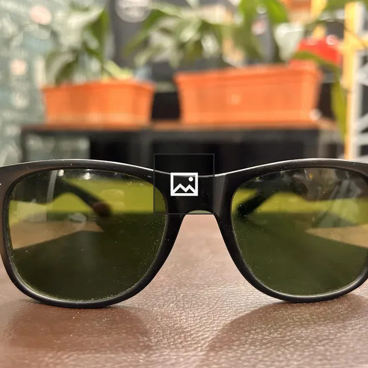 Black sunglasses on brown surface