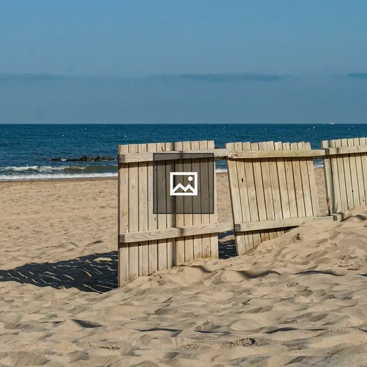 Wooden fence on sandy beach