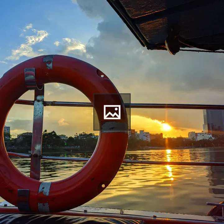 Sunset over calm water from boat