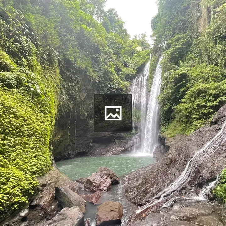 Two waterfalls flow into a pool