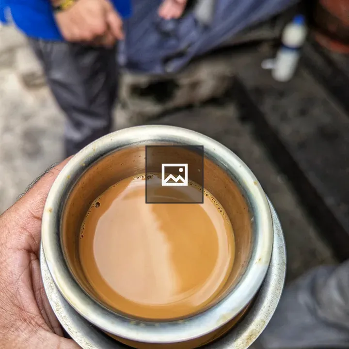 Hand holding a cup of coffee
