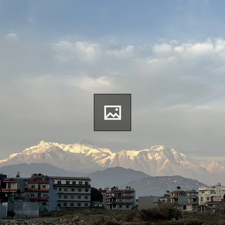 Snowy mountains and village foreground