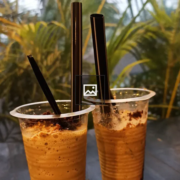 Two iced coffee cups on table