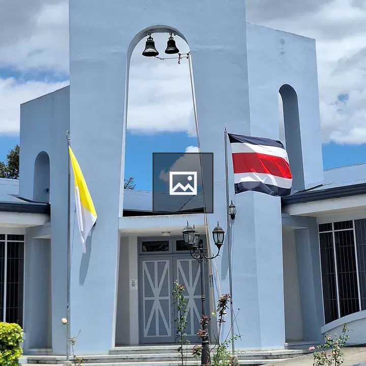 Sky-blue church with bells and flags