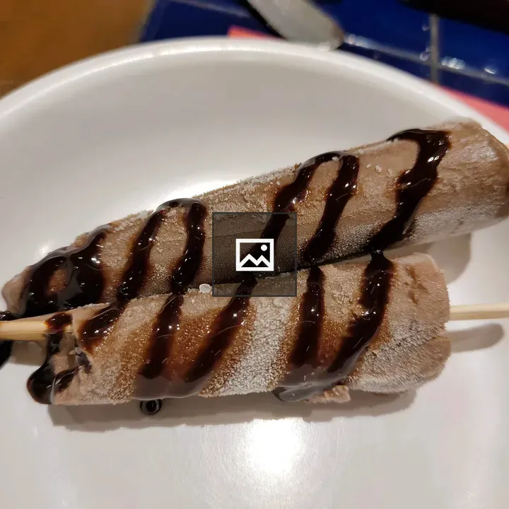 Two ice cream pops on plate
