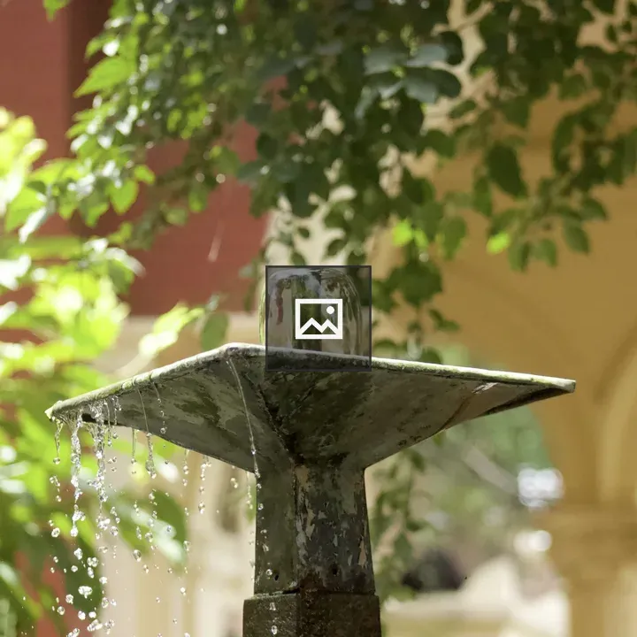 Metal fountain with green foliage