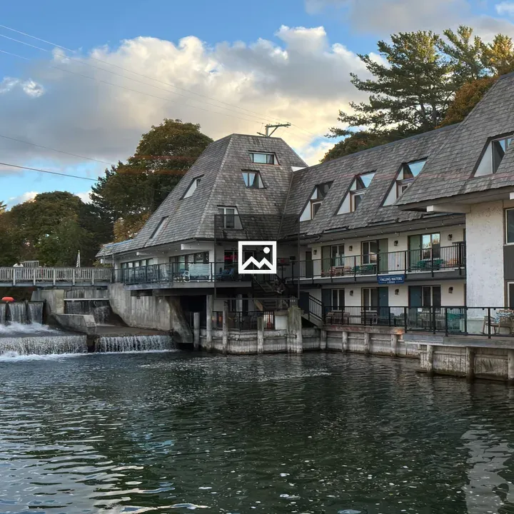 View of restaurants and fishing huts by waterfall