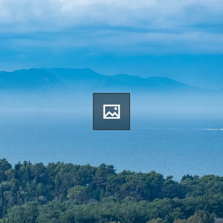Forest foreground, sea, and island landscape