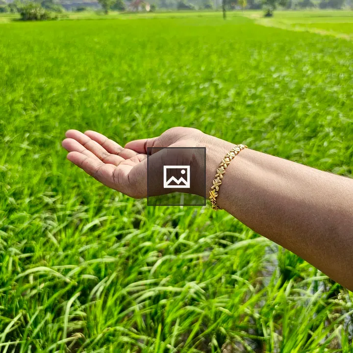 Gold bracelet on green field