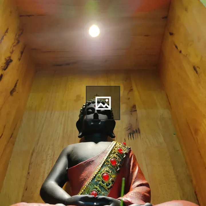 Budha statue on wooden shelf