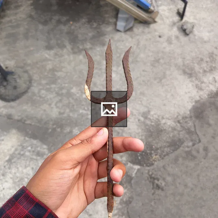 Rusty garden fork held by hand