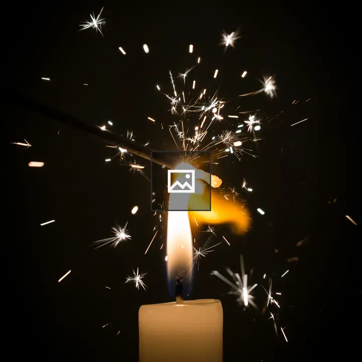 Sparkler lit by candle detail