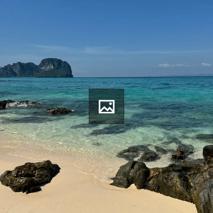 Peaceful beach with rocks and islands